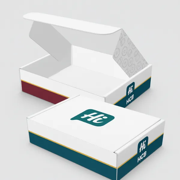 White postal boxes with Hi HCB logo - one closed- one open showing printed maroon- teal- and yellow side accents with patterned inner lid- class=