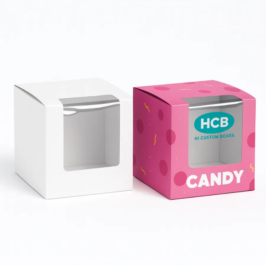 Two cube candy boxes with a clear window- one plain white and one in a pink pattern with -CANDY- text- class=