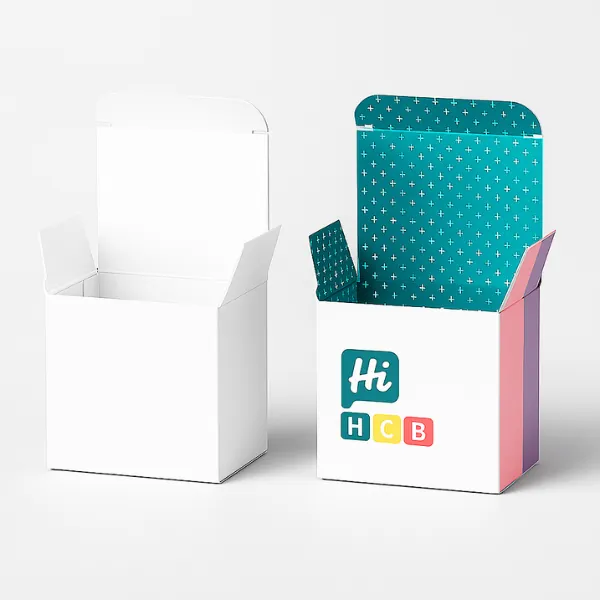 Two open folding boxes - one plain white- one with HCB branding and teal patterned interior flap- class=