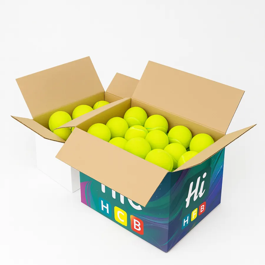 Large corrugated packaging boxes- plain white and custom Hi HCB printed- filled with multiple neon yellow tennis balls for wholesale storage- class=