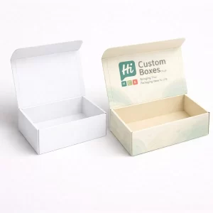 Two open cardboard mailing boxes, one plain white and one with custom green branding.