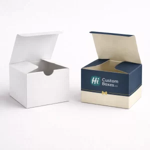 Two small square gift boxes with open lids, one plain white and one navy blue.