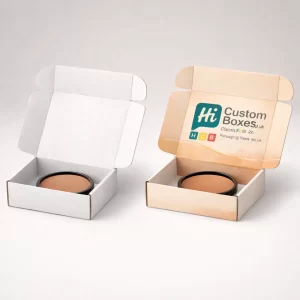 Two open mailer-style boxes featuring a central bronzer compact, one plain and one with branding.
