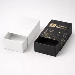 Two tall rectangular product boxes, one blank white and one printed with gold foil details.