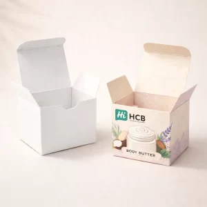 Two square two-piece rigid boxes, one plain white and one with elegant pink body butter branding.