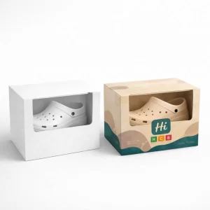 Two display boxes with transparent windows showing clogs inside, featuring both plain and branded designs.