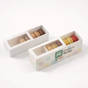 Two white drawer-style boxes with clear windows, one featuring branded pastel circle artwork on the sleeve.