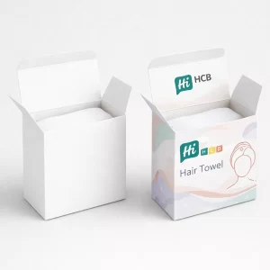 Two white square boxes, one plain and one with pastel waves and a hair towel logo.