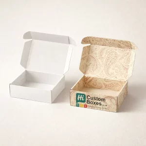 Open cardboard mailer boxes featuring a plain white interior and a detailed cream paisley printed exterior.