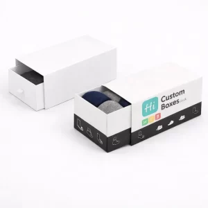 Two sleek white drawer-style slide boxes, with the branded version partially open to show socks.