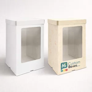 Two square white and floral patterned bakery boxes featuring clear windows and carrying handles.