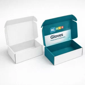An open white corrugated box next to a teal branded mailer box for wholesale gloves.