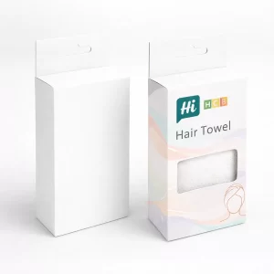Two tall white boxes with hanging tabs, one featuring a rectangular window showing a white towel.