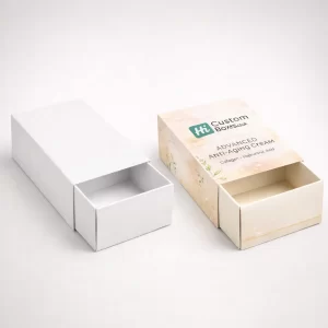 Two drawer-style slide boxes, one minimal white and one decorated with soft floral patterns and logos.