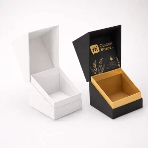 Two open cardboard mailer boxes, one plain brown and one with custom gold foil patterns.
