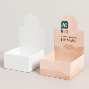 Two open-top cardboard display trays- one white and one with peach -HCB- branding