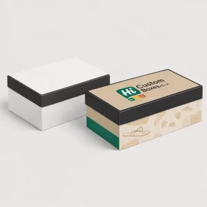 A plain white shoebox next to a branded beige sandal box with a black lid.