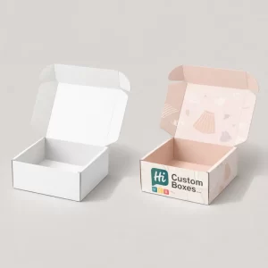 Open cardboard mailer boxes, one plain white and one featuring a pink interior with a skirt-themed pattern.