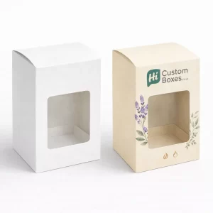 Two soy candle boxes with clear windows, shown in natural brown and branded floral finishes.