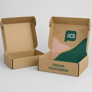 Kraft corrugated mailer box mockup with plain version on the left and custom printed version on the right, showcasing inside lid design with pastel graphics and "HCB Cream Packaging" branding.