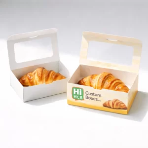 Sturdy cardboard croissant packaging boxes with carry handles for convenient and stylish bakery product transport.