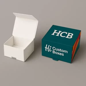 Open plain white box beside closed HCB display box with colourful striped side design
