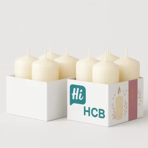 Two rectangular tray-style boxes holding cream-colored candles- One is plain white- while the other has custom printed design with teal- pink- and candle illustrations along with -Hi HCB- branding