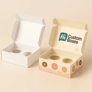 Open custom printed donut box with two circular inserts and donut-themed graphics, alongside a plain white box with similar inserts.