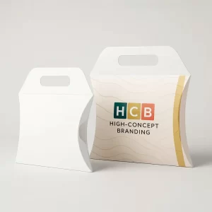 Two pillow-shaped apparel boxes- one plain white and one printed with the HCB logo