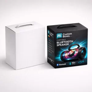 A plain white box next to a black portable speaker box featuring a carry handle.
