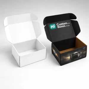 Two open cardboard mailing boxes- one plain white and one black with camera branding