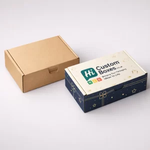 Two rectangular cardboard mailers, one plain brown and one navy blue with gold festive illustrations.