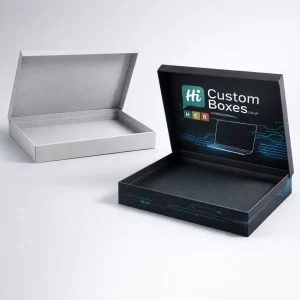 Two sleek, slim-profile laptop gift boxes with hinged lids in minimalist grey and branded black options.