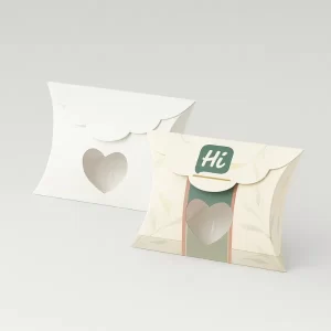 Two small pillow boxes with scalloped edges and a heart-shaped cutout window design