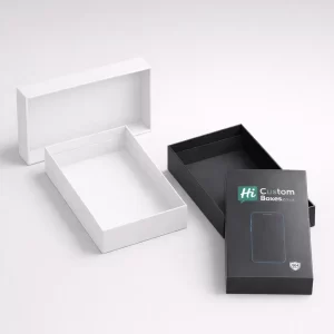 An open white two-piece box beside a black branded lid featuring a smartphone outline and logo.