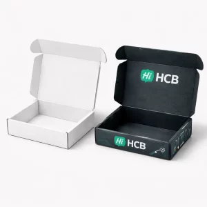 Two sturdy cardboard shipping boxes, one plain white and one with dark blue circuit-style brand patterns.