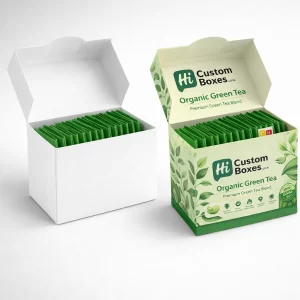 Two open flip-top boxes filled with green tea sachets, one plain white and one branded.