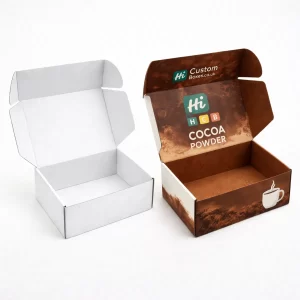 A simple white rectangular carton beside a cream and brown printed cocoa powder retail box