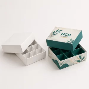 Elegant two-piece rigid boxes with internal grid dividers for organizing small luxury items or confectionery.
