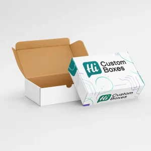 Two closed rectangular mailer boxes- one plain white showing its kraft interior- and one white box custom-printed with the -Hi Custom Boxes- logo and light purple and teal line graphics