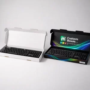 Two open keyboard boxes, one plain white and one black with colourful graphics, containing black keyboards.
