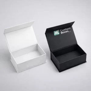 Two premium magnetic gift boxes with open lids, shown in minimalist matte white and matte black.
