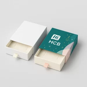 White and branded drawer-style gift boxes- pulled open- showing felt inserts for jewellery