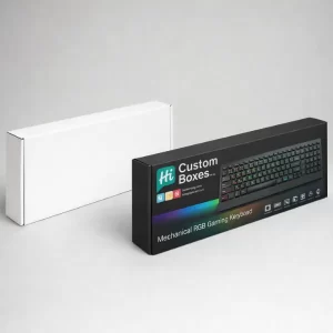 A plain white rectangular box positioned behind a black printed box featuring a gaming keyboard illustration.