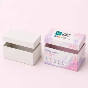 Two square mailing boxes, one white and one decorated with purple flowers and brand logo.