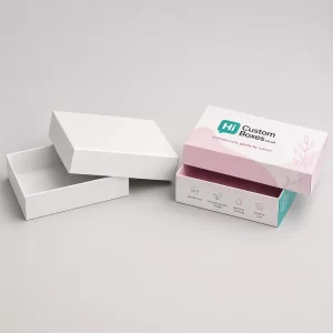 An open and closed purple floral branded box designed for intimate cream tube packaging.