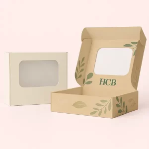 Two rectangular soap boxes with windows - one plain cream- one kraft with leafy HCB branding inside