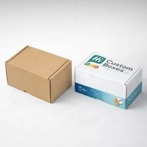 Two small rectangular mailing boxes, one natural brown Kraft and one with custom printed branding.
