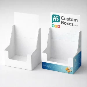 Two cardboard retail display stands, one plain white and one printed with blue pharmaceutical branding.