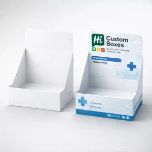Two cardboard counter display units, one plain white and one printed with blue medical branding.